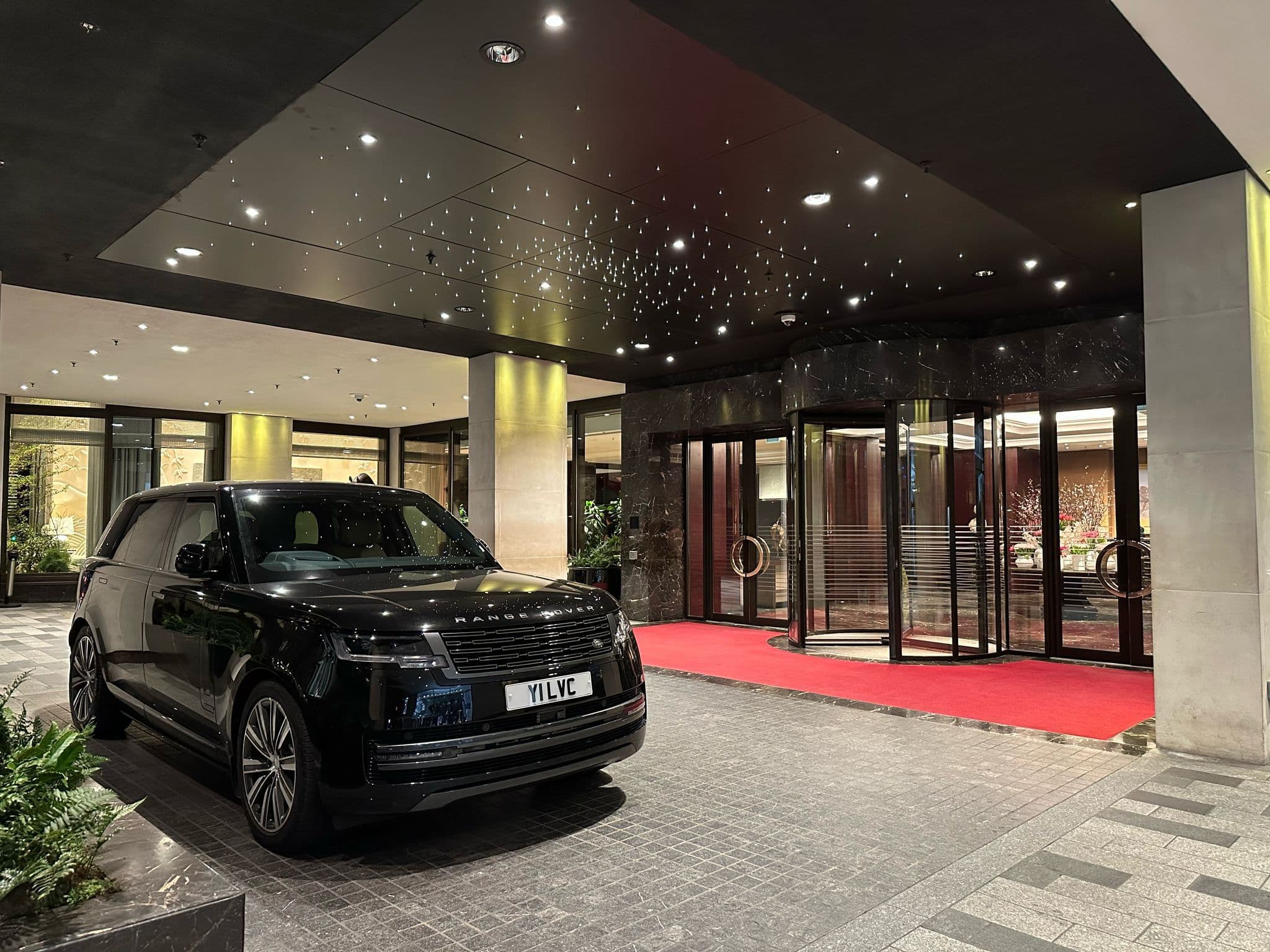 Luxury London car service with chauffeur waiting outside Four Seasons Hotel providing premium private driver transport