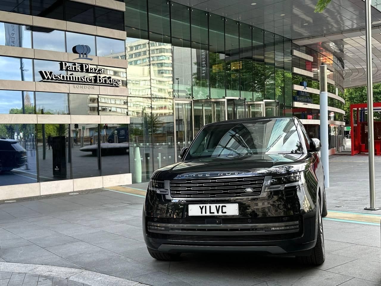 Black SUV waiting outside Park Plaza Westminster Hotel for arriving clients.